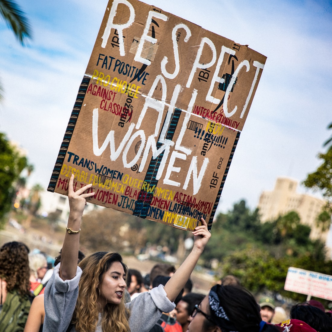 A woman with a placard written respect all women