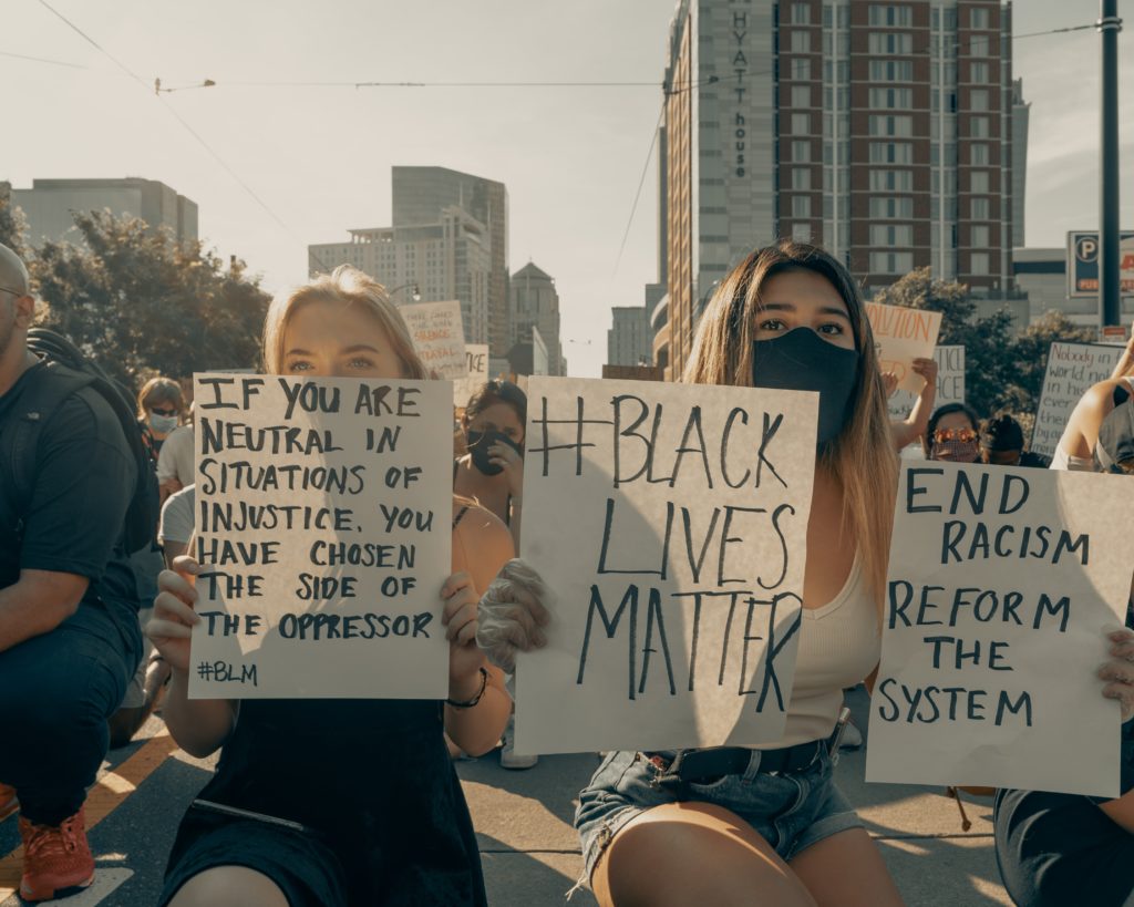 Two protesters holding signs for equality